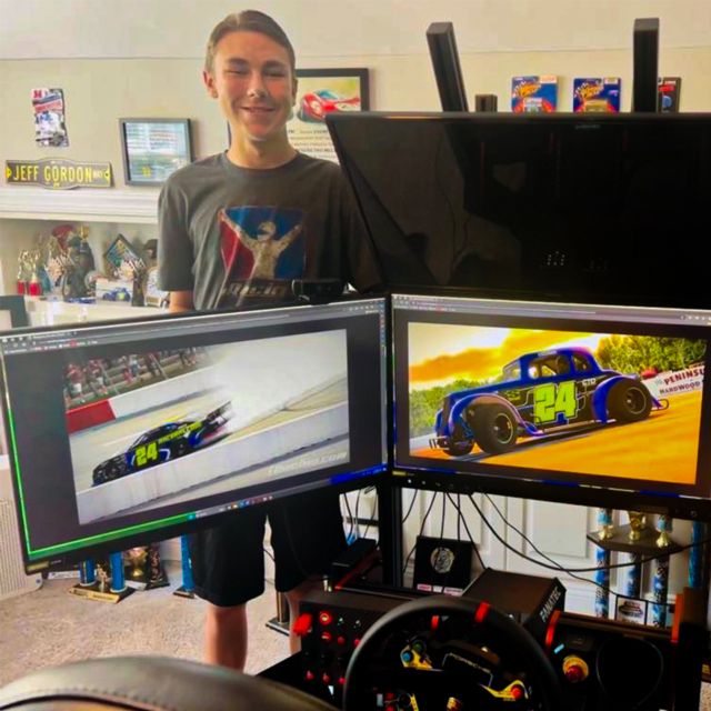 Joel Smith stands next to his personal iRacing rig.